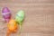 Artificial color eggs on wooden plank background. For Easter day