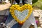 Artificial flowers in the shape of a heart and candlesticks lie on the tombstone in the cemetery.