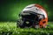 Artificial grass forms background for minimalist American football helmet