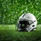 Artificial grass forms background for minimalist American football helmet