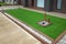 Artificial grass or synthetic lawn turf with timber garden edging in a landscaped front yard garden of an Australian home.