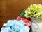 Artificial hydrangea flowers on wooden table