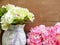 Artificial hydrangea flowers on wooden table