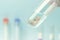 Artificial insemination. Test tube baby, IVF. A human embryo in a glass tube on a blue laboratory background. concept of