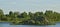 An artificial island in the pond with a hill, where many water birds have settled