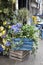 Artificial ivy and purple hydrangea in wooden tubs decorate an outdoor cafe