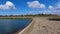 An artificial lake for fishing. A bridge for fishermen on the lake. Lake fishing.