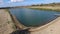 An artificial lake for fishing. A bridge for fishermen on the lake. Lake fishing.