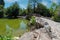 Artificial lake with wooden bridge at the National Garden of Athens - Greece. It is a public park in the center of Athens city