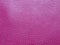 Artificial leather is bright pink or fuchsia. Distinct furrows and elevations on the surface of a bag or shoe. Reflection of the