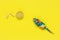 Artificial mouse and ball for playing cats on a bright yellow background. View from above. Colorful knitted pet toys