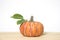 Artificial pumpkin on wooden floor