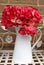 Artificial red hydrangea in white jug