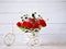 Artificial red rose flowers in bike toy on table bouquet bucket Bicycle with soft tone for festive background or wallpaper
