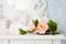 Artificial rose flowers on a white wooden table