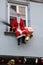 Artificial Santa Claus with gift packages on window sill