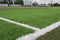 Artificial sports surface green grass imitation on the football stadium