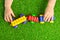 Artificial turf. Baby plays with a building kit train on a green artificial grass.