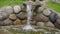 An artificial waterfall created by human hands. Water flows down the stones into the pond, landscaping. Background for