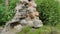 An artificial waterfall created by human hands. Water flows down the stones into the pond, landscaping. Background for