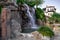 Artificial waterfall from a stone wall on the tourist embankment in Alanya Turkey. Decorative natural fountain on promenade near