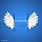Artificial white paper wings on blue background.