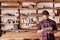 Artisan carpenter in his woodwork studio using digital tablet