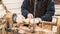 An artisan carves a piece of wood using a manual lathe.