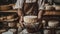 Artisan cheese maker holding matured wheels of cheese