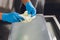 Artisan cheesemaker cuts the mozzarella with hands.