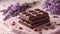 Artisan chocolate bars with lavender on a delicate pink surface