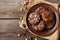 Artisan chocolate cookies with sea salt and caramel on rustic plate