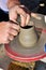 Artisan creates a clay pot with a lathe