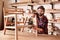 Artisan furniture designer sanding a chair in his workshop