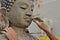 Artisan hands making clay buddha