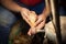 Artisan hands at work, carving wood into spoons