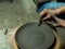 Artisan making a clay pot with hands