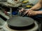 Artisan making a clay pot with hands