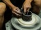 Artisan making a clay pot with hands