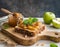 Artisan Multigrain Toast with Chunky Apple Preserve and Fresh Mint on a Carved Wooden Board