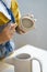 Artisan occupation: young woman working in studio creating clay jug for retail store small business