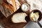 Artisan sliced toast bread with butter and sugar on wooden cutting board. Simple breakfast on grey concrete background