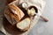 Artisan sliced toast bread with butter and sugar on wooden cutting board. Simple breakfast on grey concrete background