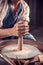 Artisan woman making ceramic pottery on wheel. National craft. Close-up.