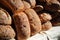 Artisanal bread loaves stacked on table- horizontal