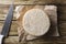 Artisanal Canastra cheese from Minas Gerais, Brazil with knife over paper on a wooden table