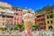 Artisanal gelato with a view of colorful houses in Vernazza, Cinque Terre, Italy