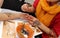 Artist applying henna tattoo on women hands