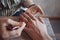 Artist applying henna tattoo on women hands.