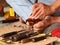 Artist carving wooden BUDDHA figure with primitive self-made tools and small hammer